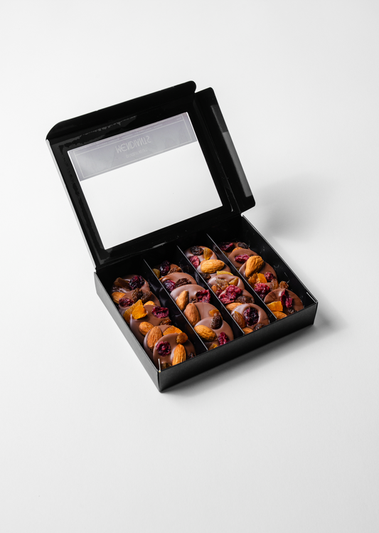 milk chocolate medallion topped with crunchy nuts and dried fruits.